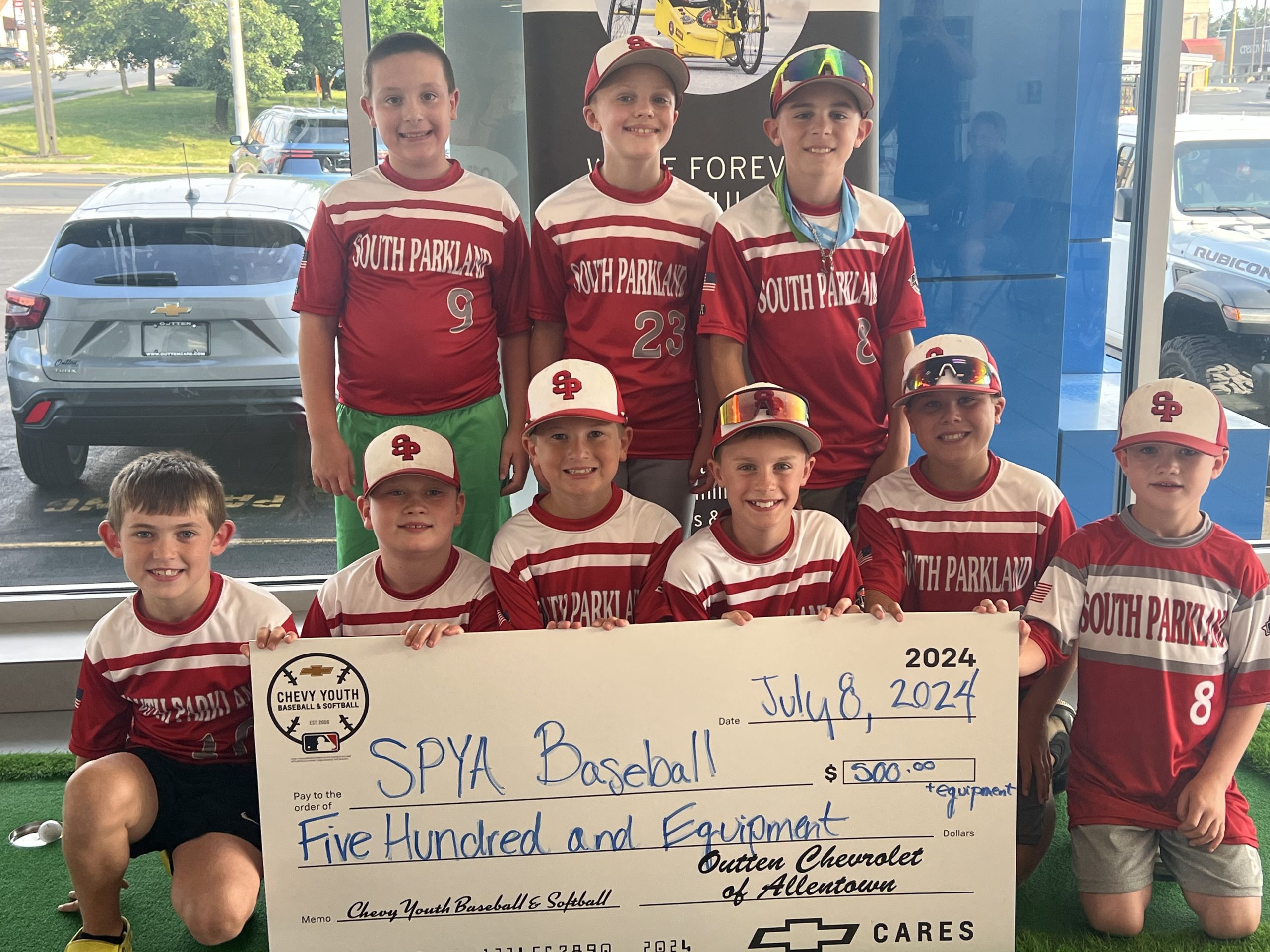 SPYA Baseball team at car dealership for sponsorship